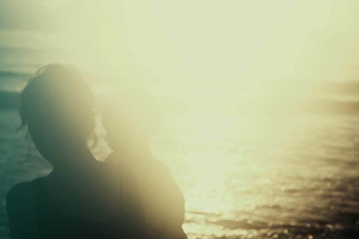 cocoa beach silhouette photography of person carrying a child light
